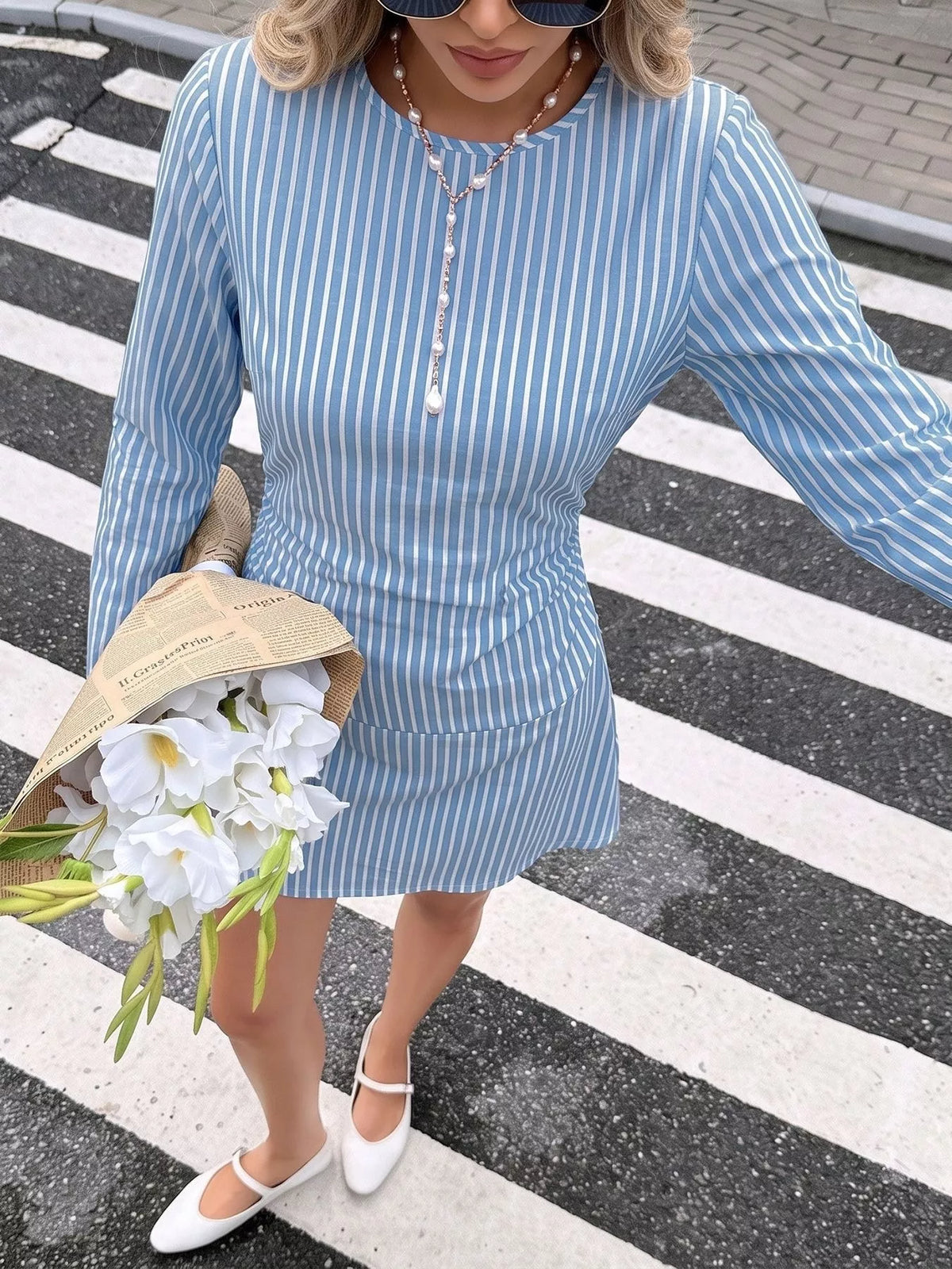 View 3 of the long-sleeve striped mini dress, ruched along the body, with a zipper and tie.