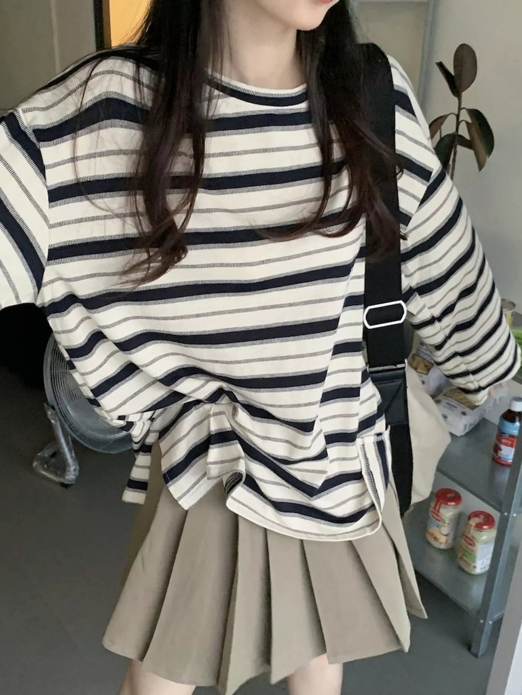 Oversized navy-and-cream striped tee with dropped shoulders.