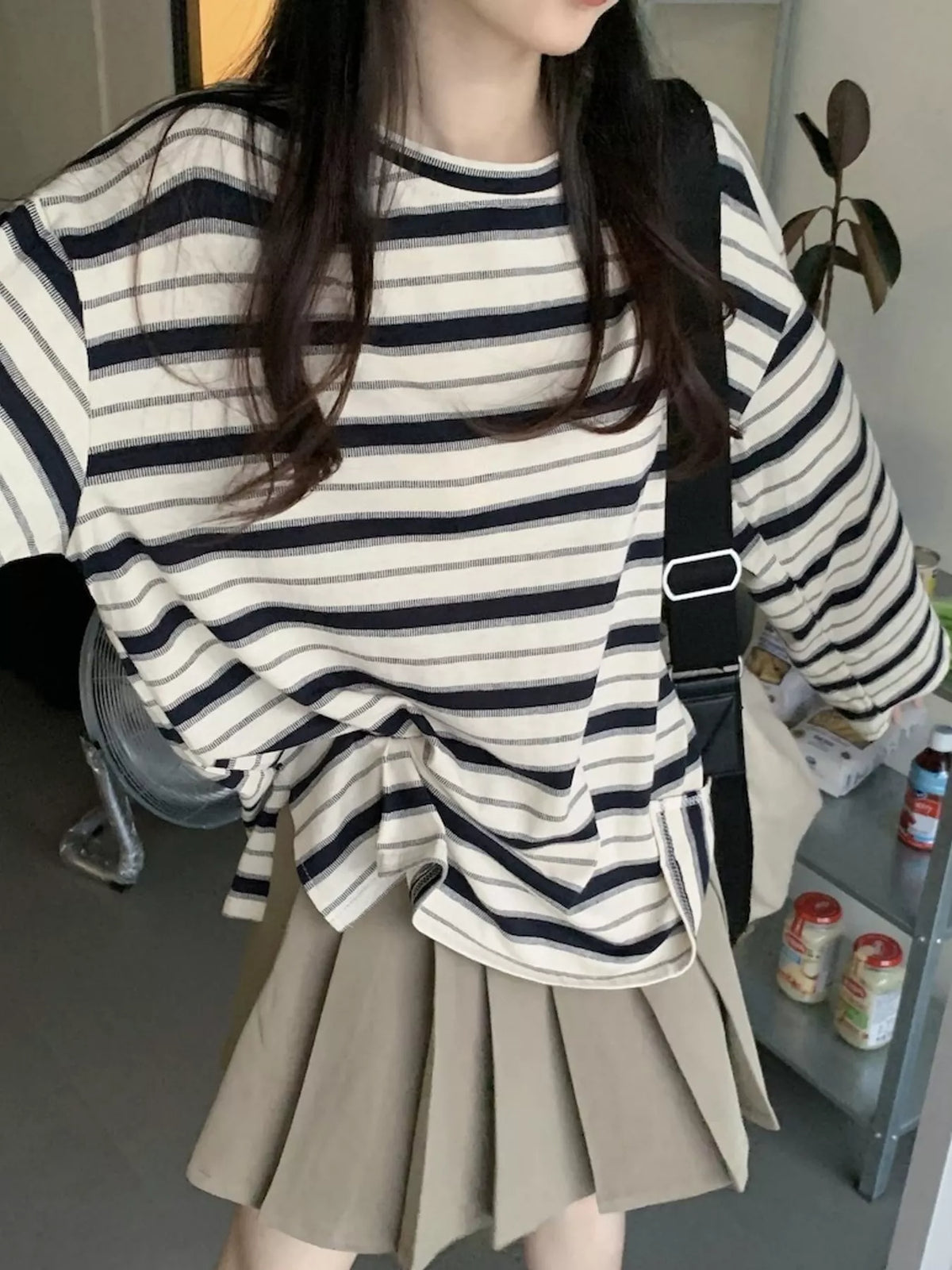 Oversized navy-and-cream striped tee with dropped shoulders.