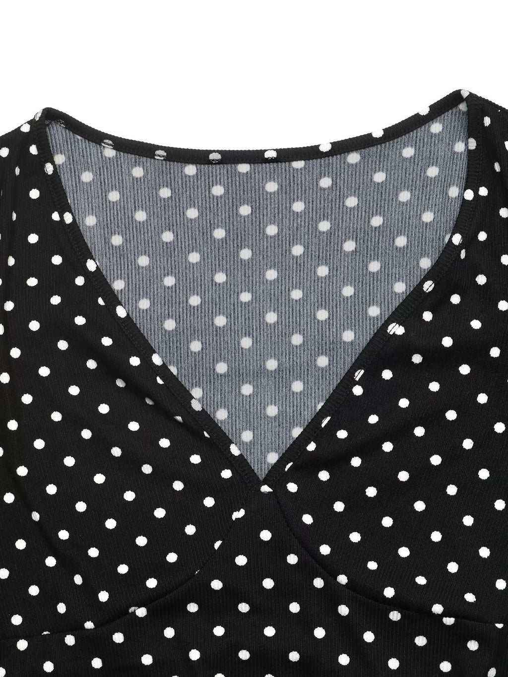 View 7 of the black long-sleeve polka-dot mini dress with a deep V and ruffled cuffs.