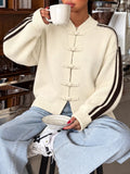 Cardigan with Chinese knot buttons and contrast stripes down the sides.
