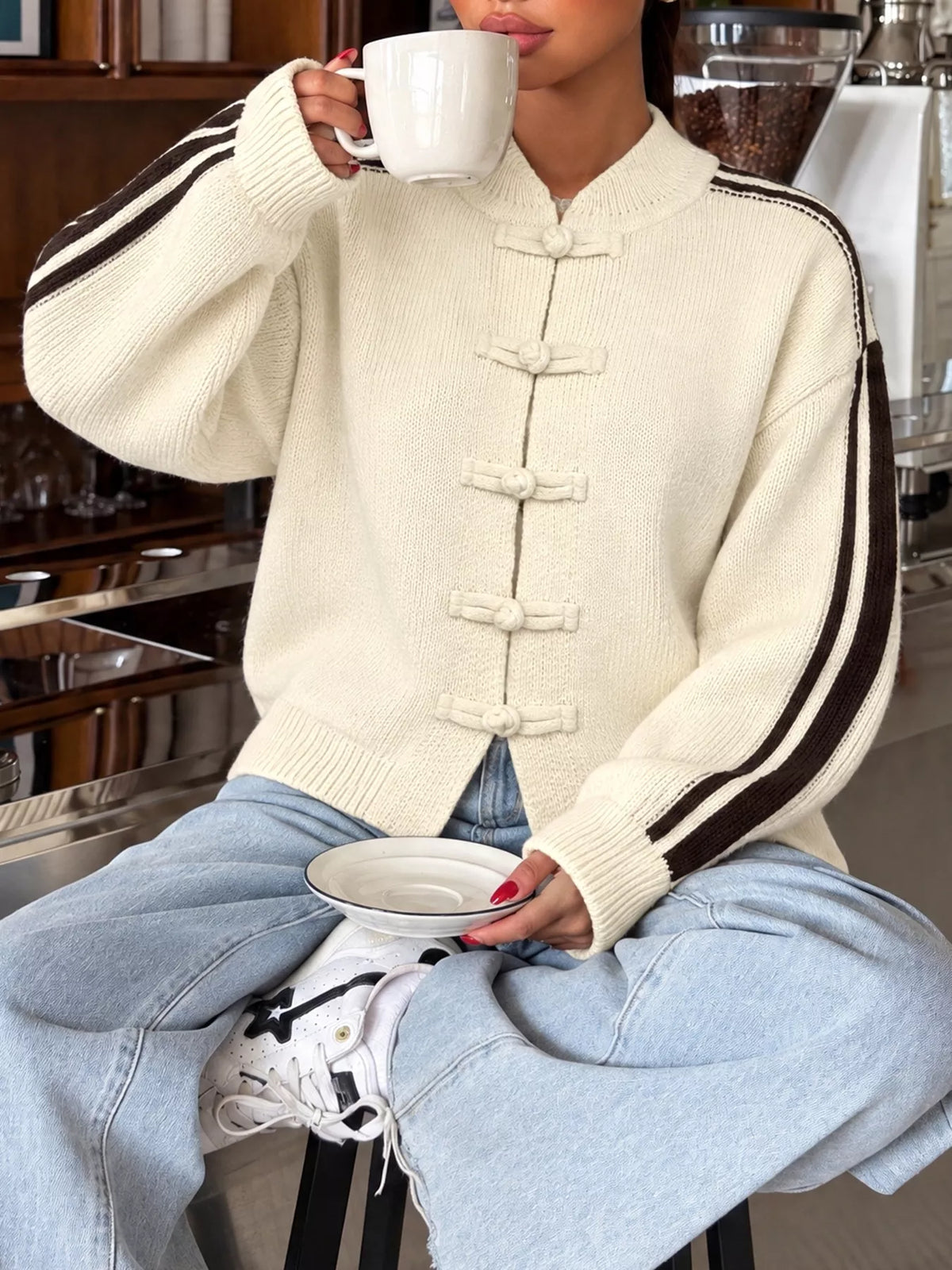 Cardigan with Chinese knot buttons and contrast stripes down the sides.