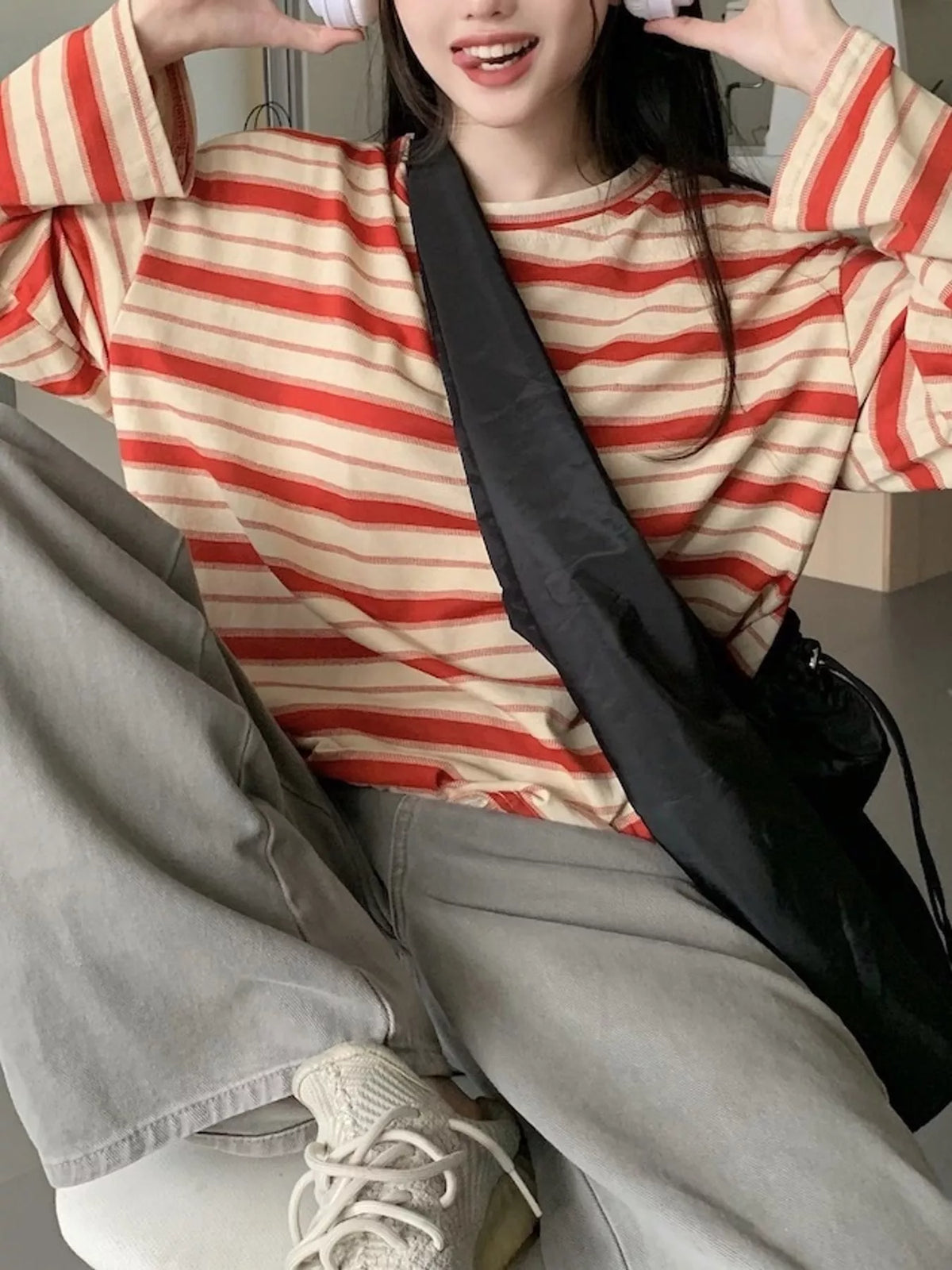 View 18 of the oversized navy-and-cream striped tee with dropped shoulders.