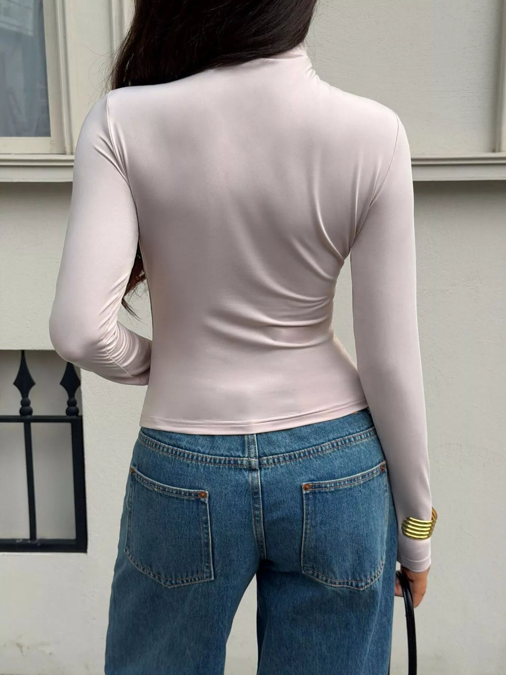 View 5 of the taupe long-sleeve mock-neck top with ruching down one side.