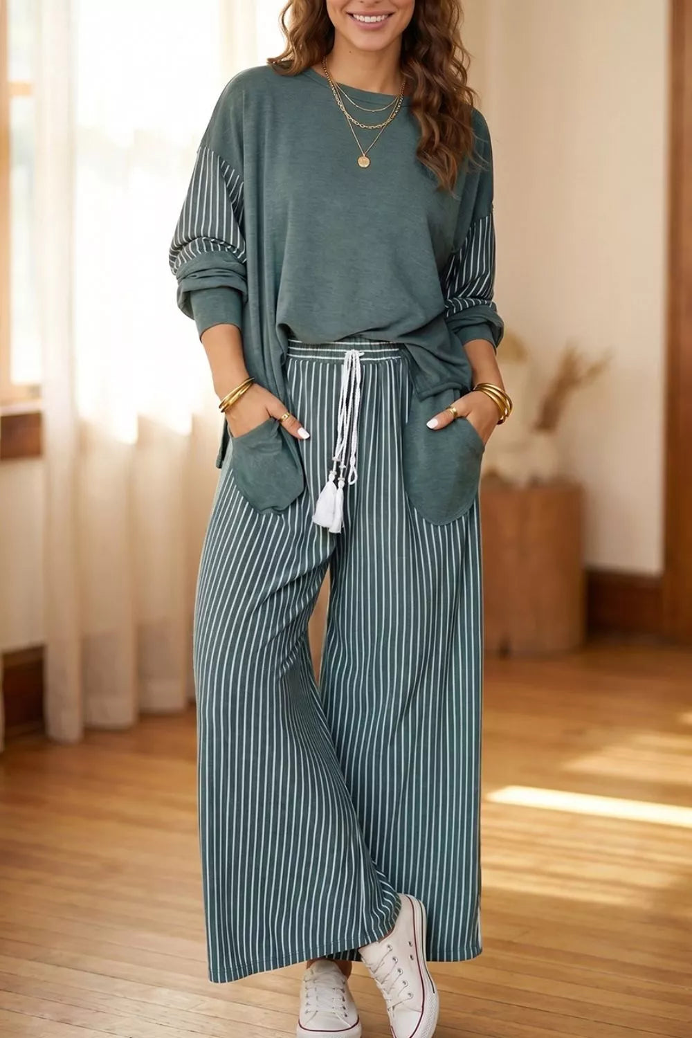 Striped two-piece set with a long-sleeve top and drawstring pants.
