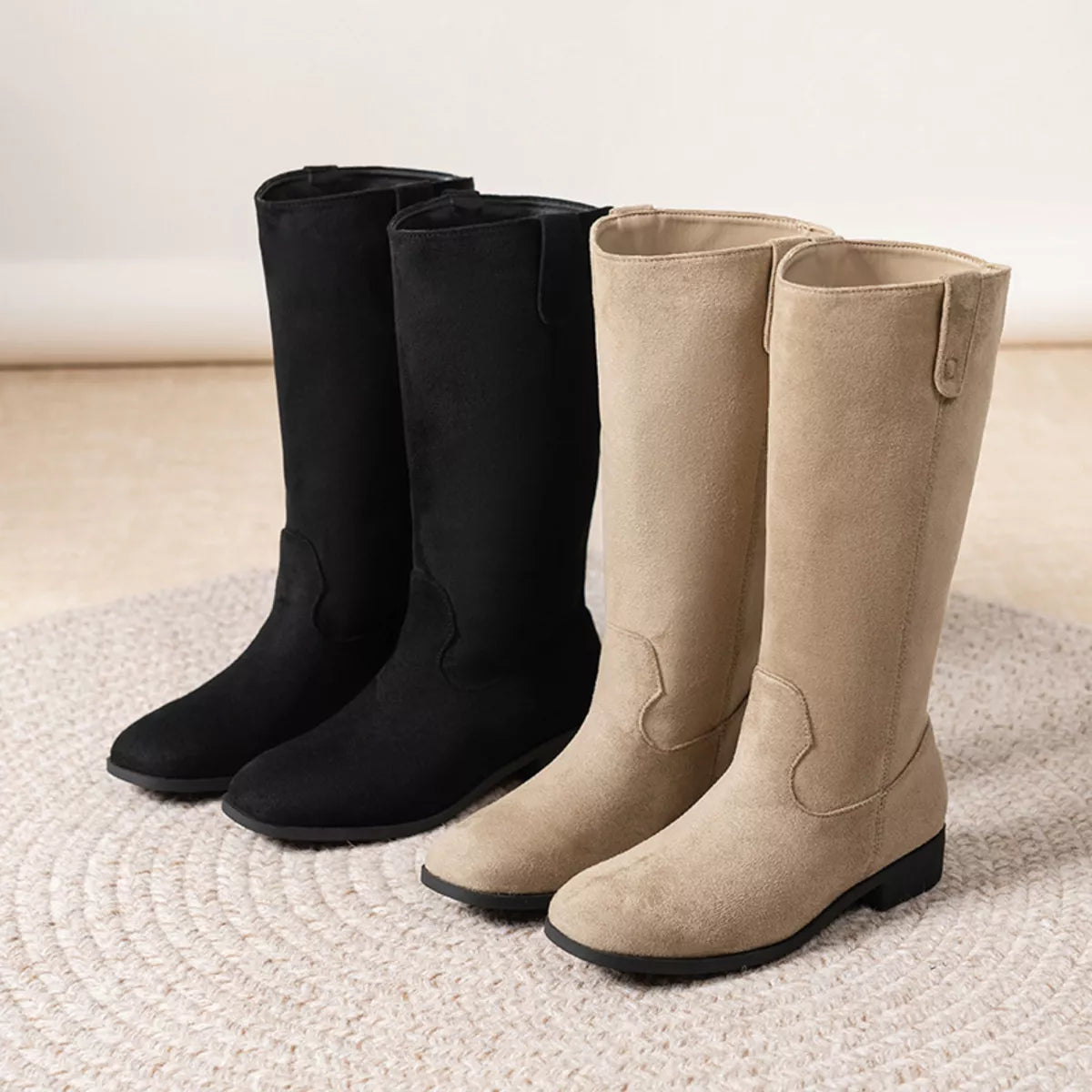 Suede pull-on boots with a round toe and a mid heel.
