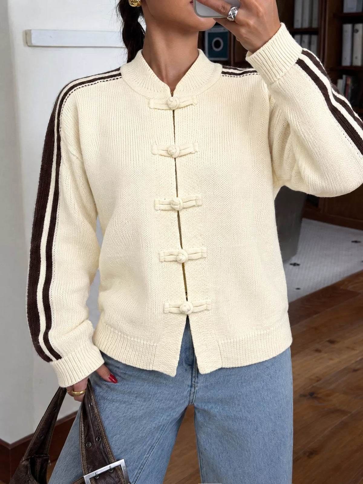 View 3 of the cardigan with Chinese knot buttons and contrast stripes down the sides.