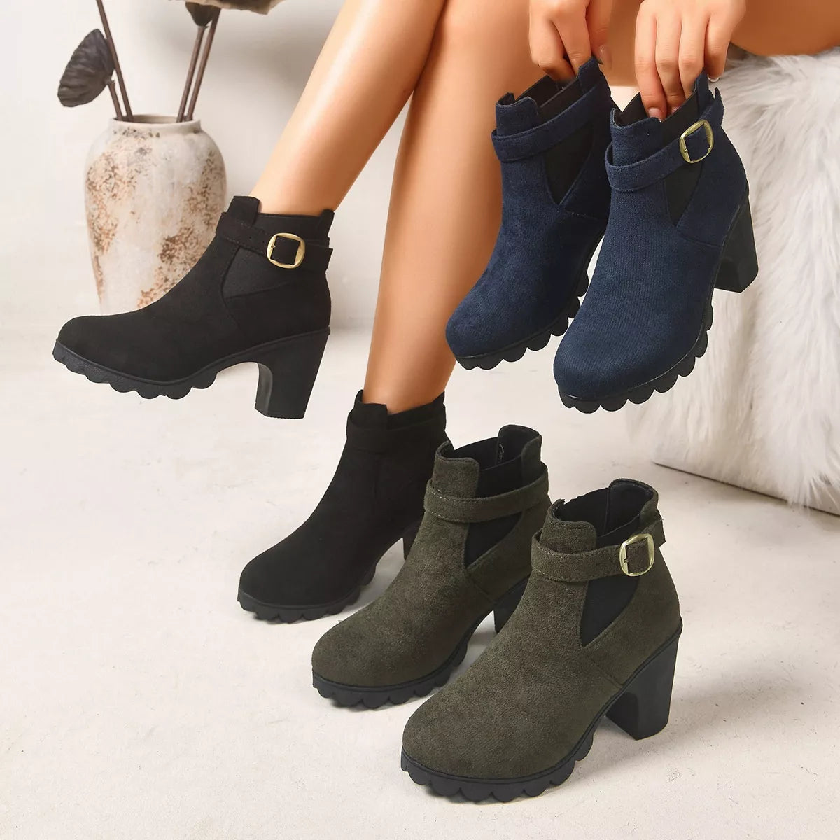 Suede boots with a round toe and a high block heel.