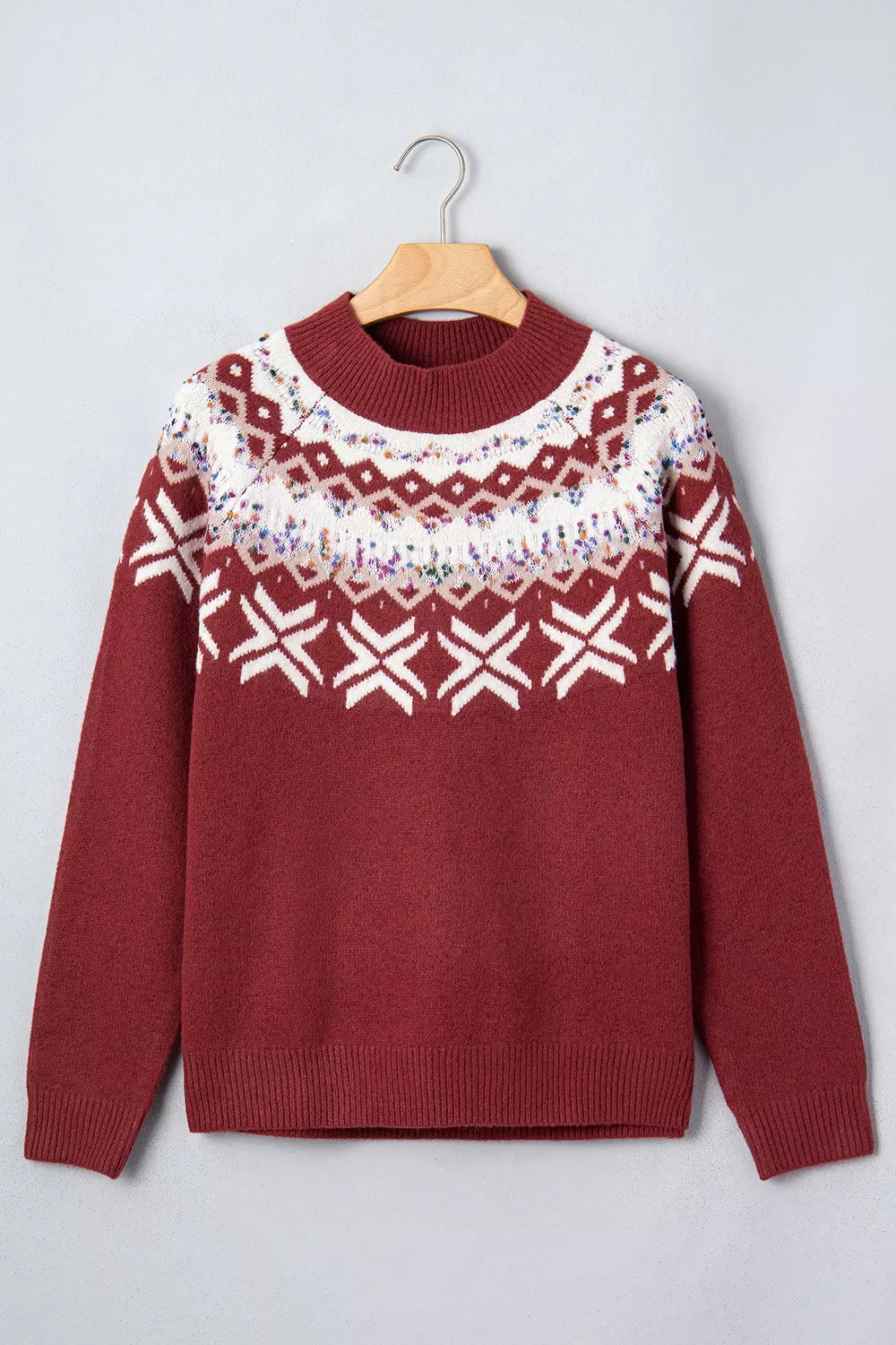 View 6 of the burgundy crewneck sweater with a white snowflake geometric band and a fair-isle yoke.