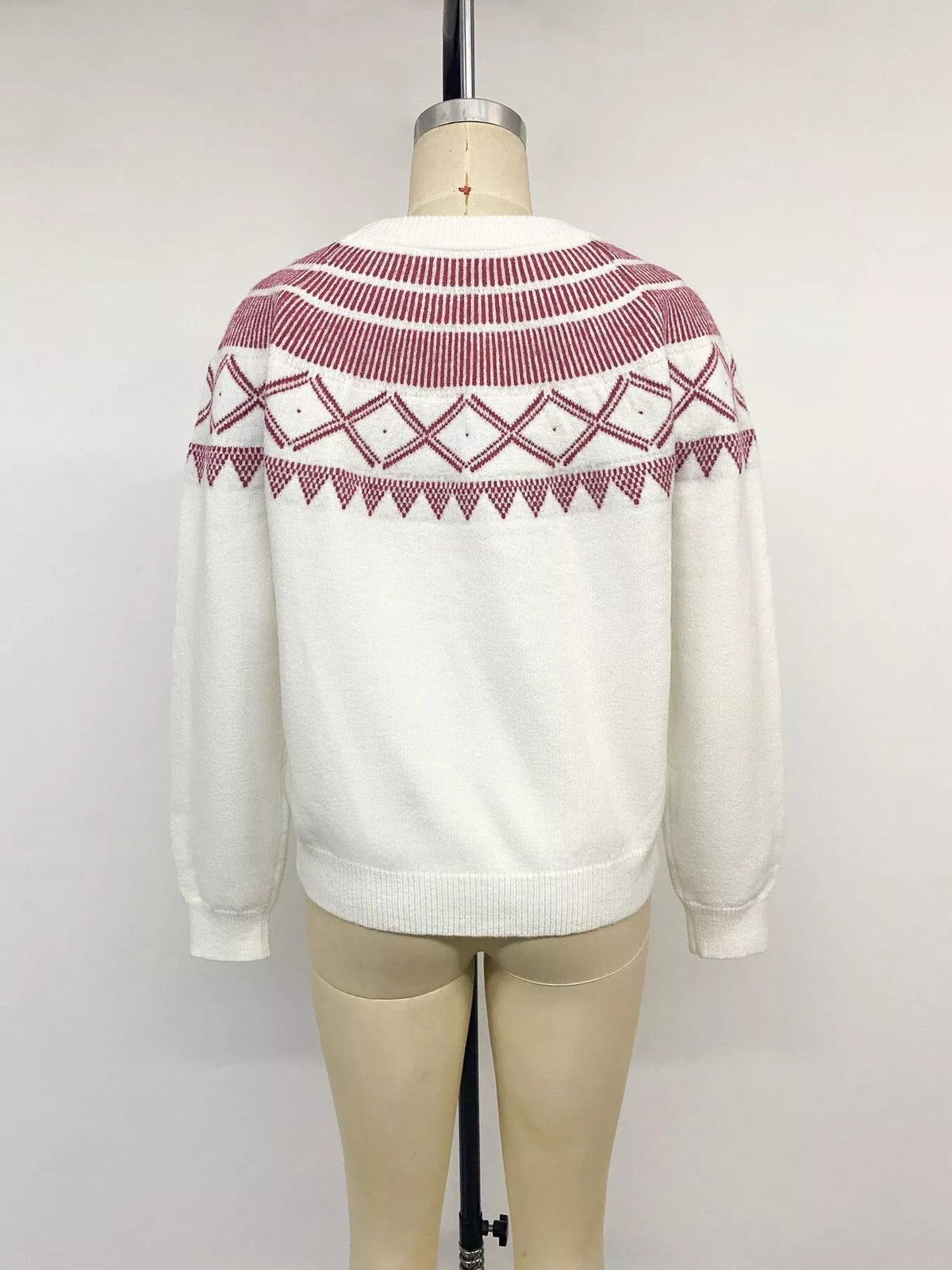 View 15 of the crewneck knit sweater covered in a geometric pattern.