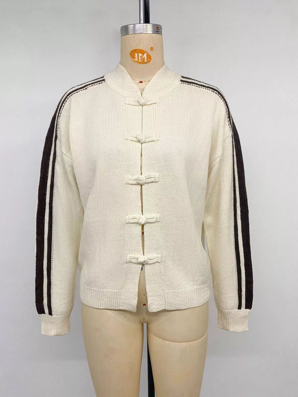 View 12 of the cardigan with Chinese knot buttons and contrast stripes down the sides.