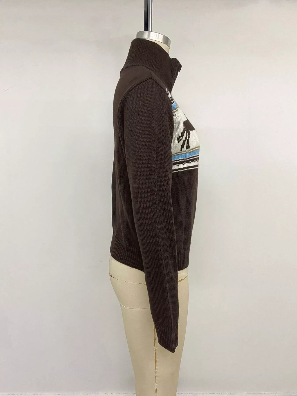 View 12 of the brown zip mock-neck cardigan with black horses on a cream chest band.