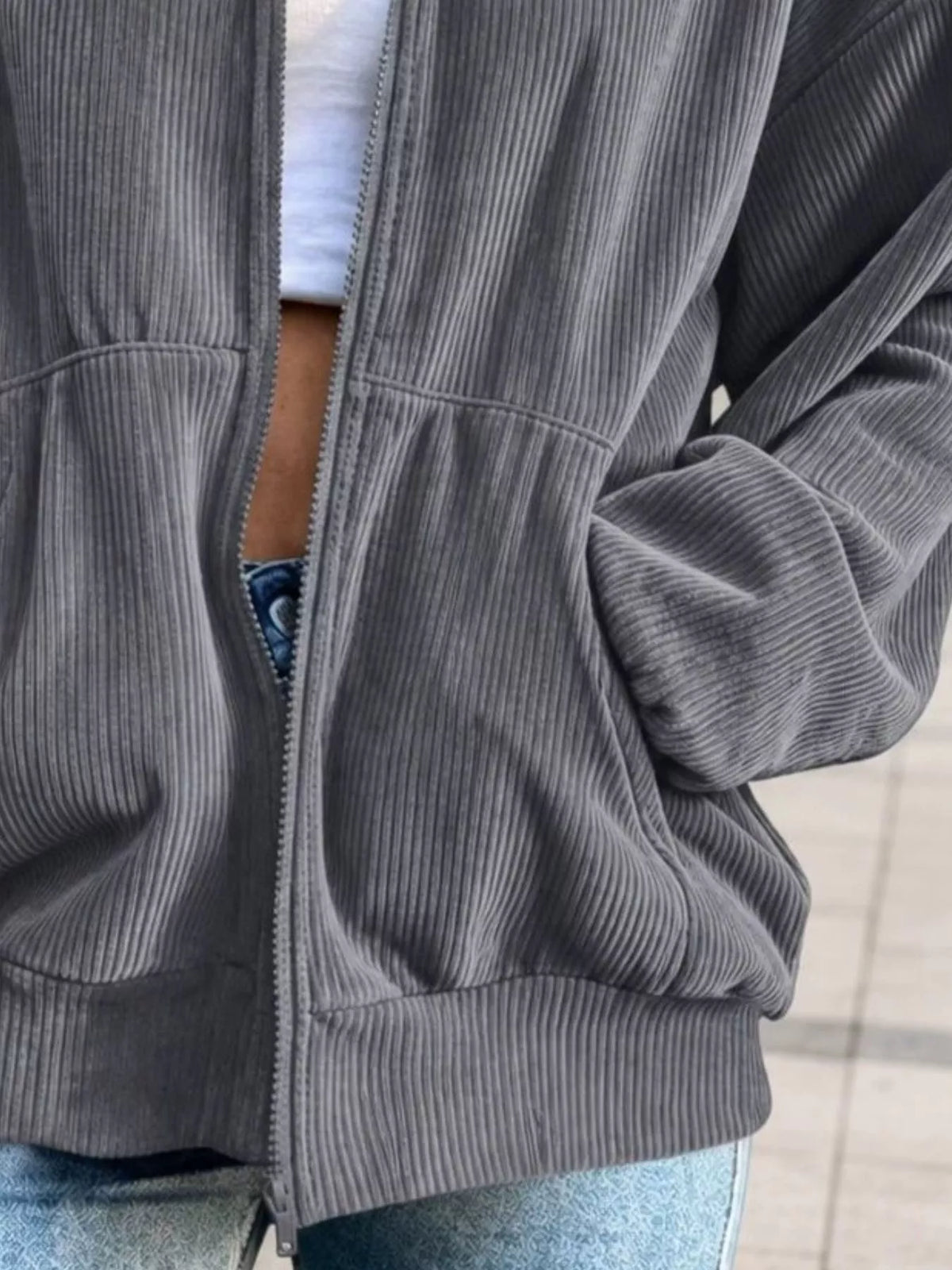 View 9 of the unlined corduroy zip jacket with dropped shoulders and pockets.
