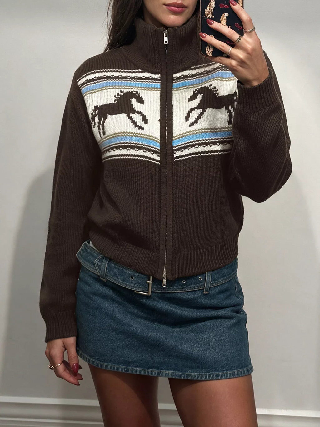 Brown zip mock-neck cardigan with black horses on a cream chest band.