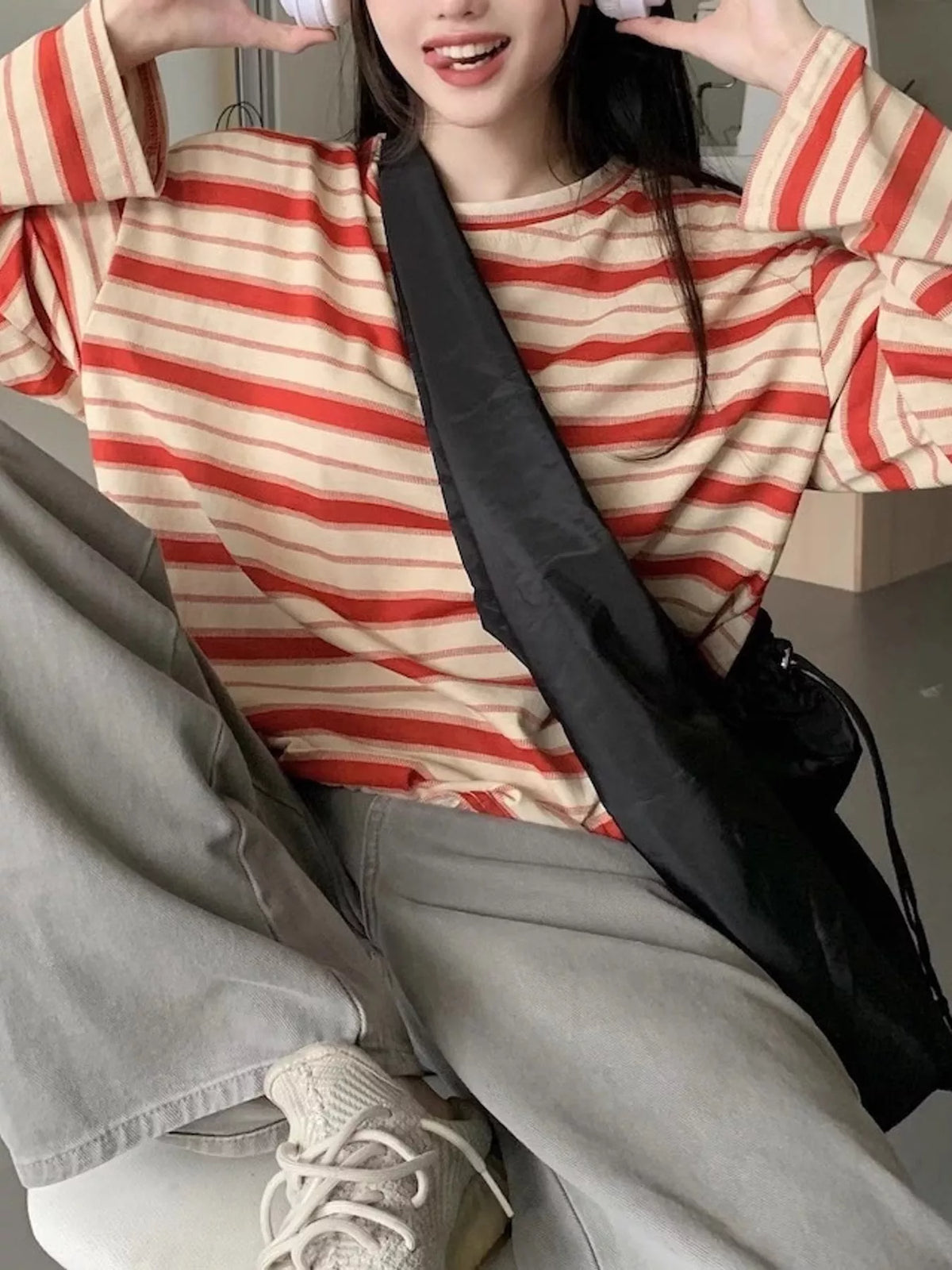 View 20 of the oversized navy-and-cream striped tee with dropped shoulders.