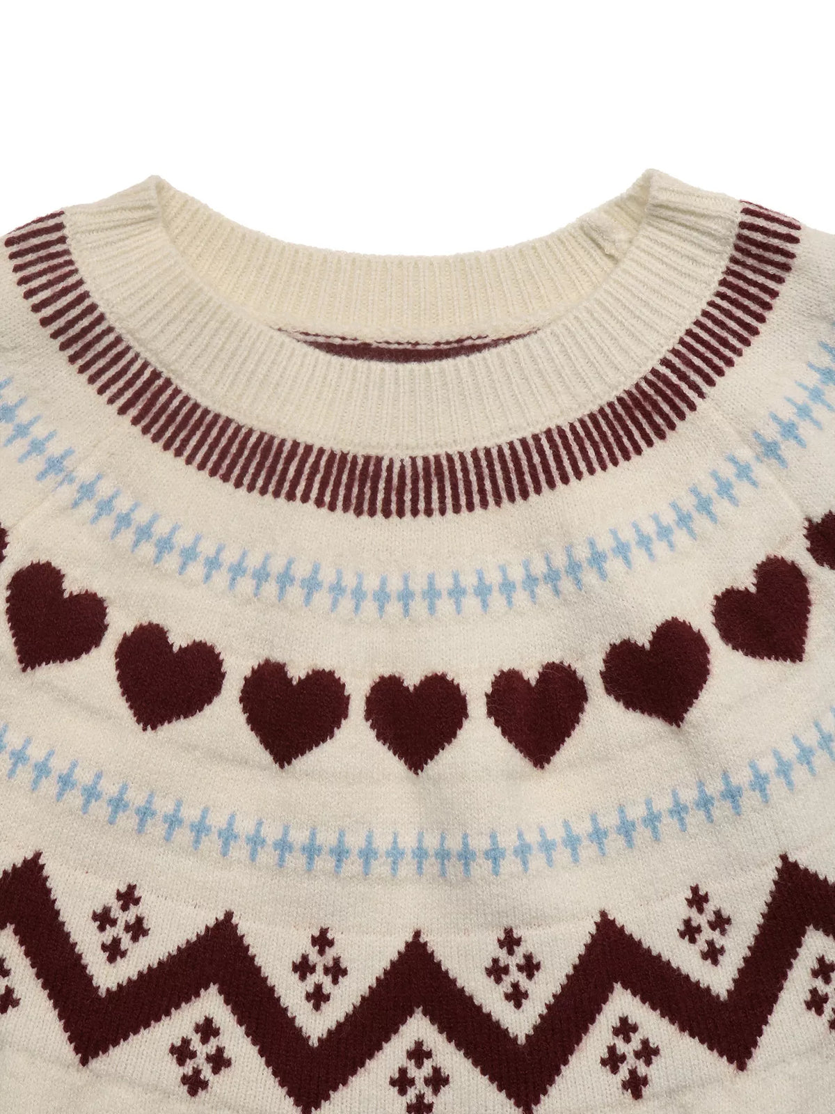 View 8 of the crewneck sweater with a heart pattern through the knit.