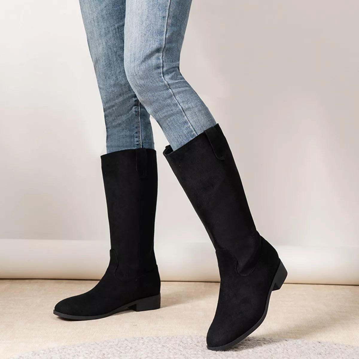 View 3 of the suede pull-on boots with a round toe and a mid heel.