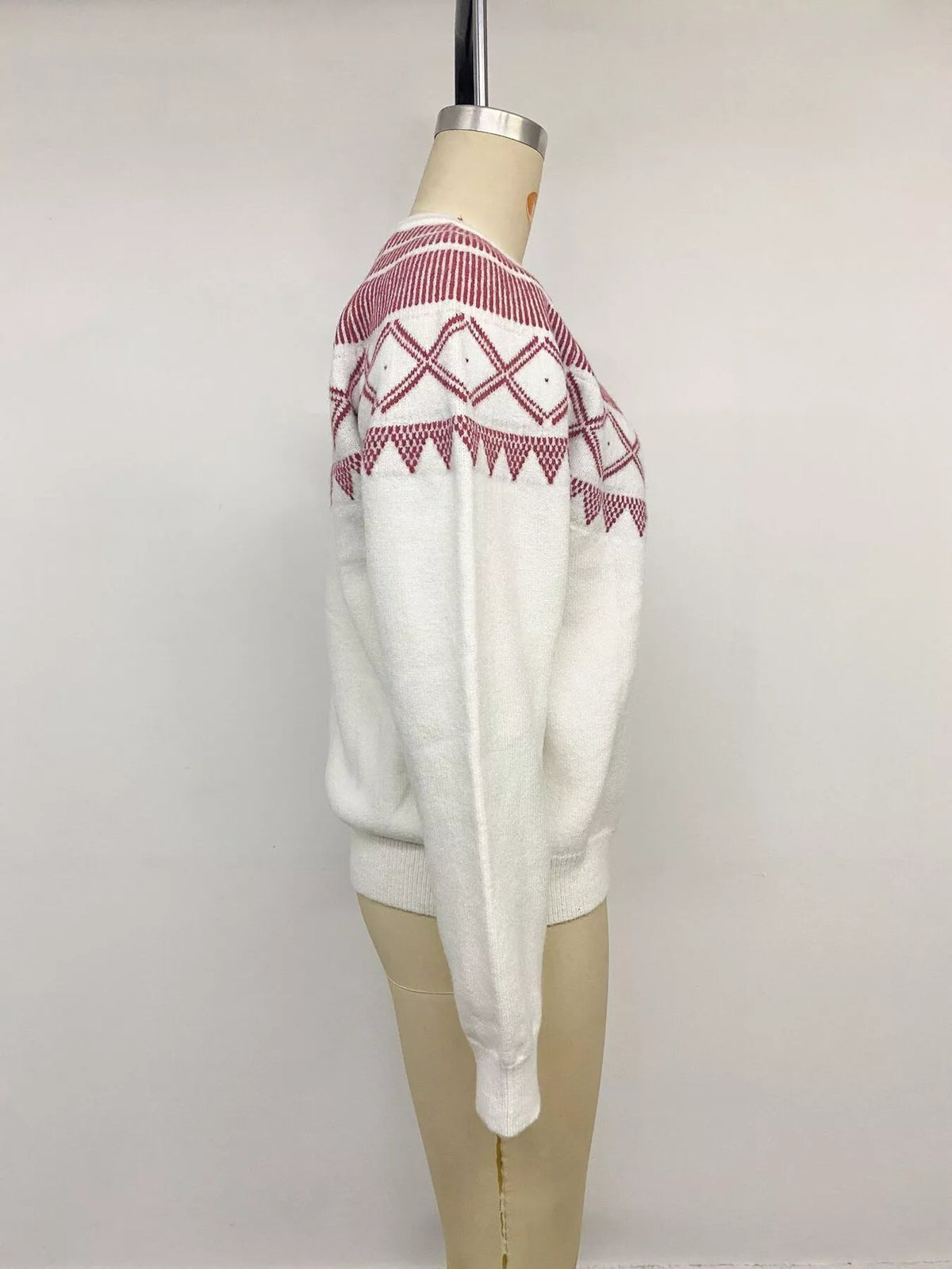 View 14 of the crewneck knit sweater covered in a geometric pattern.