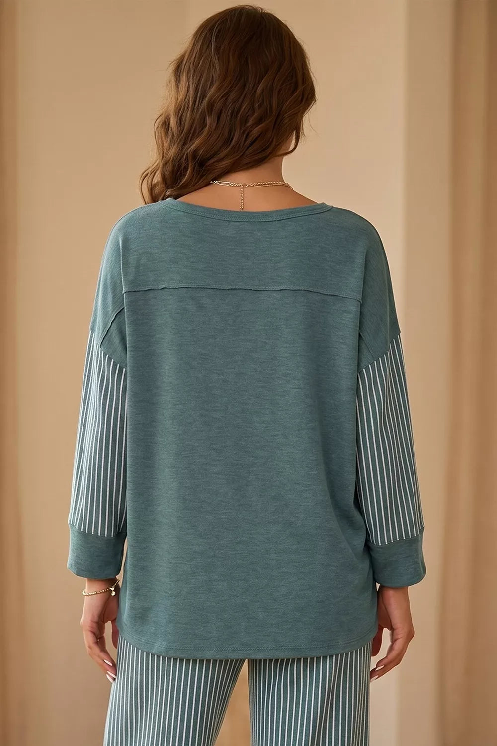 View 2 of the striped two-piece set with a long-sleeve top and drawstring pants.