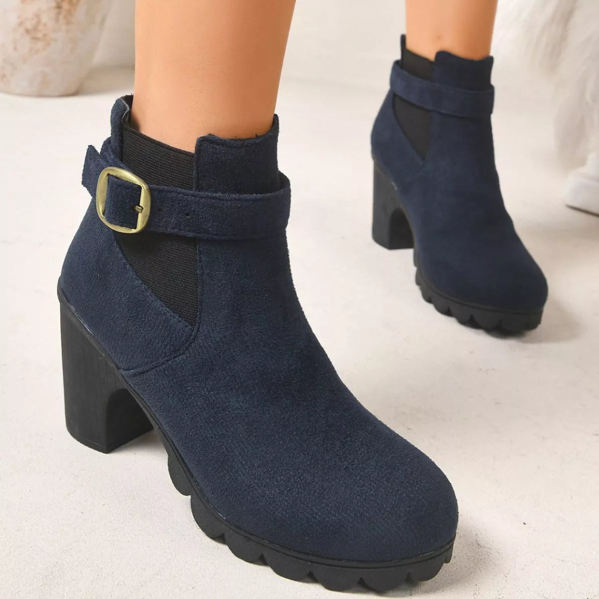 View 4 of the suede boots with a round toe and a high block heel.