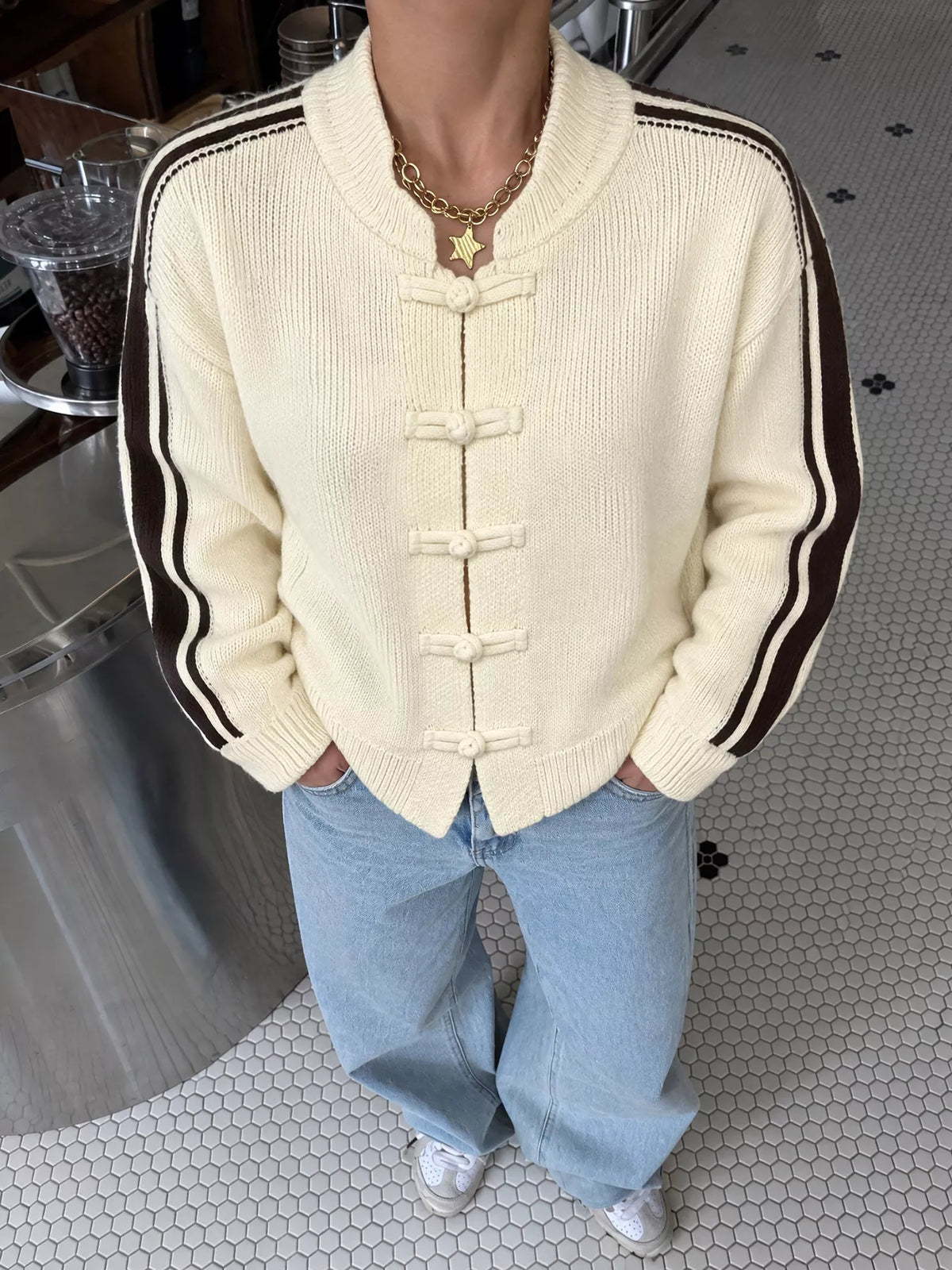 View 2 of the cardigan with Chinese knot buttons and contrast stripes down the sides.