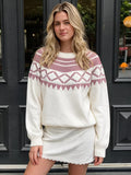 Crewneck knit sweater covered in a geometric pattern.