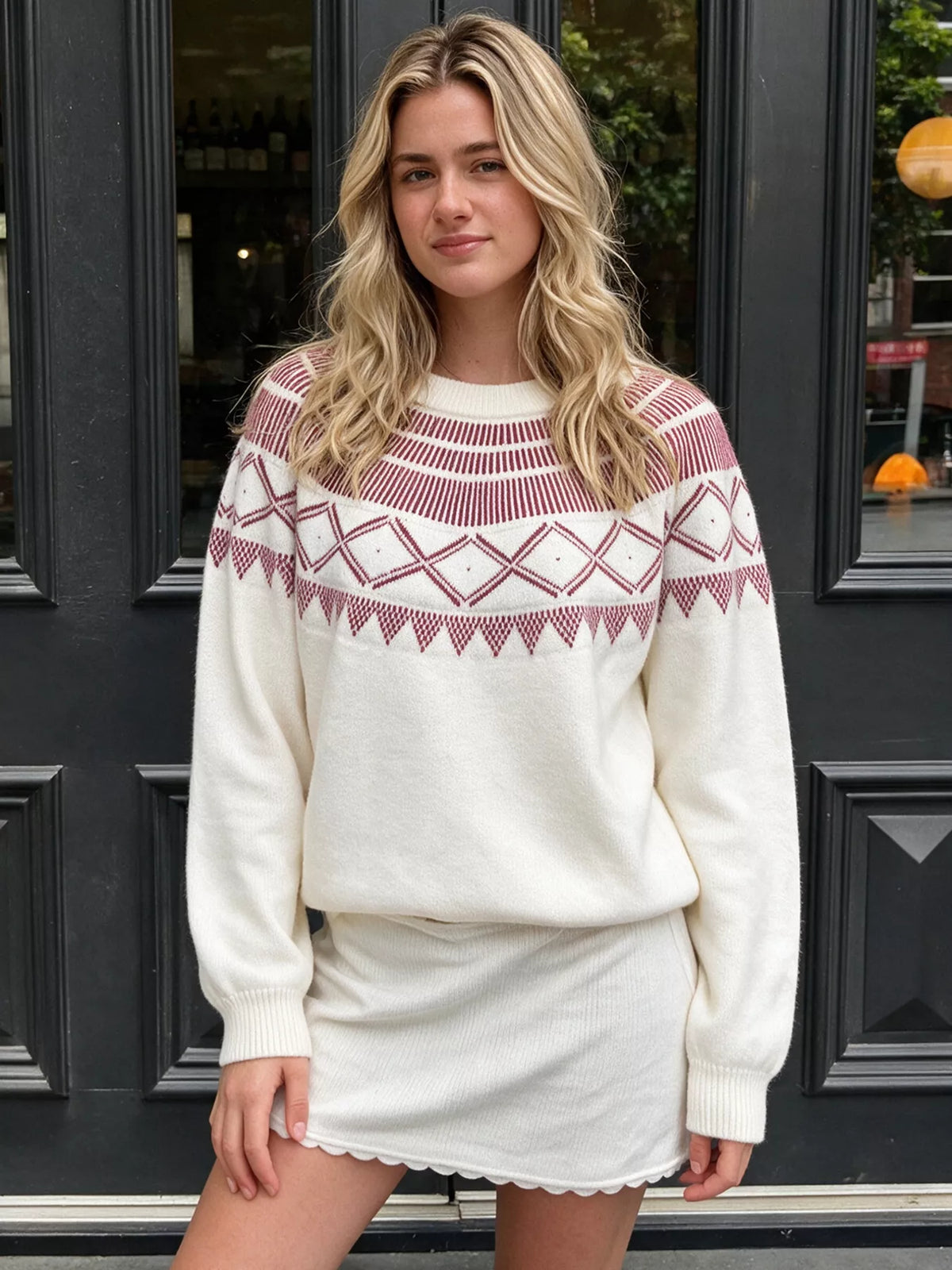 Crewneck knit sweater covered in a geometric pattern.