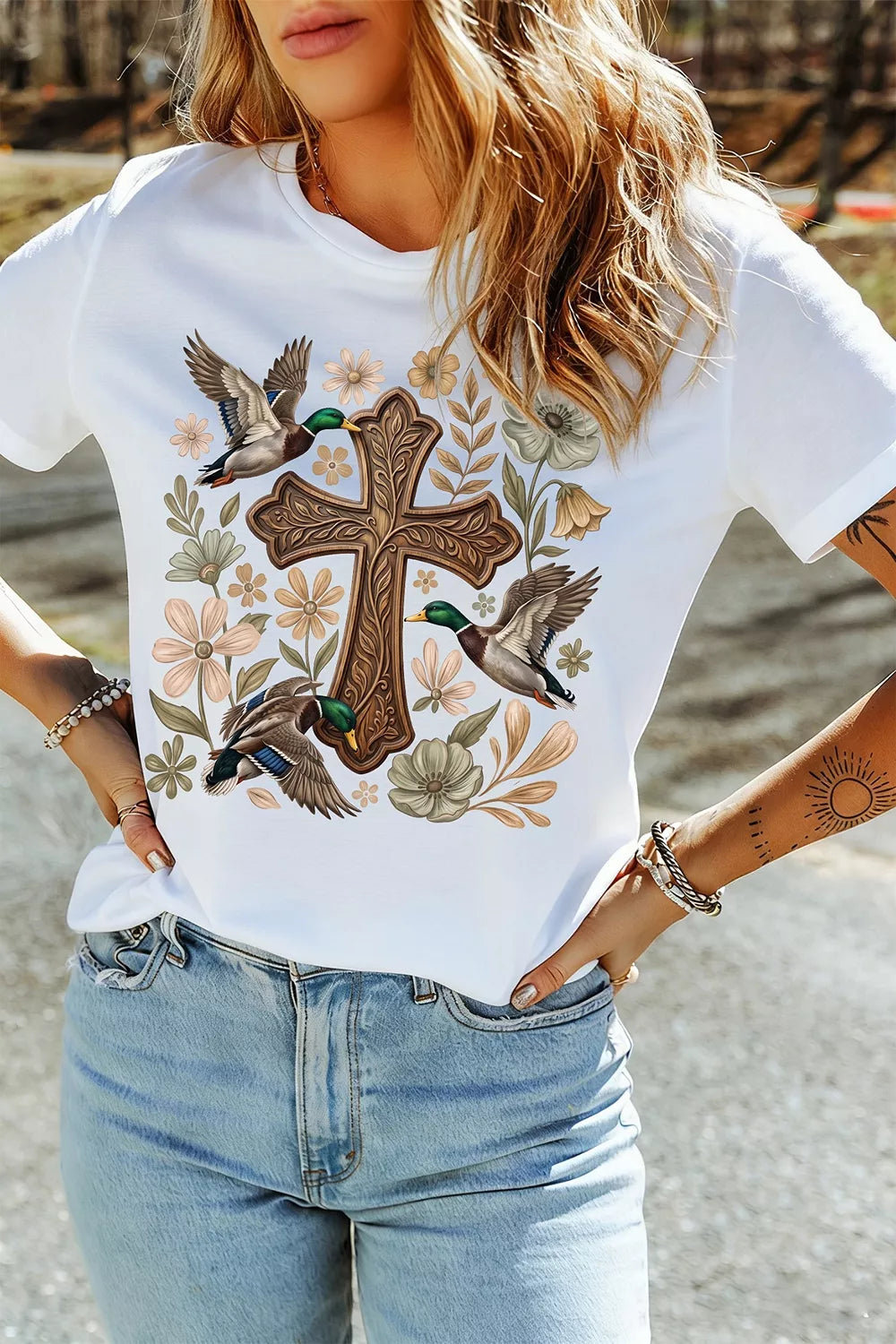 View 2 of the cream short-sleeve tee with a cross, mallard, and flower graphic.