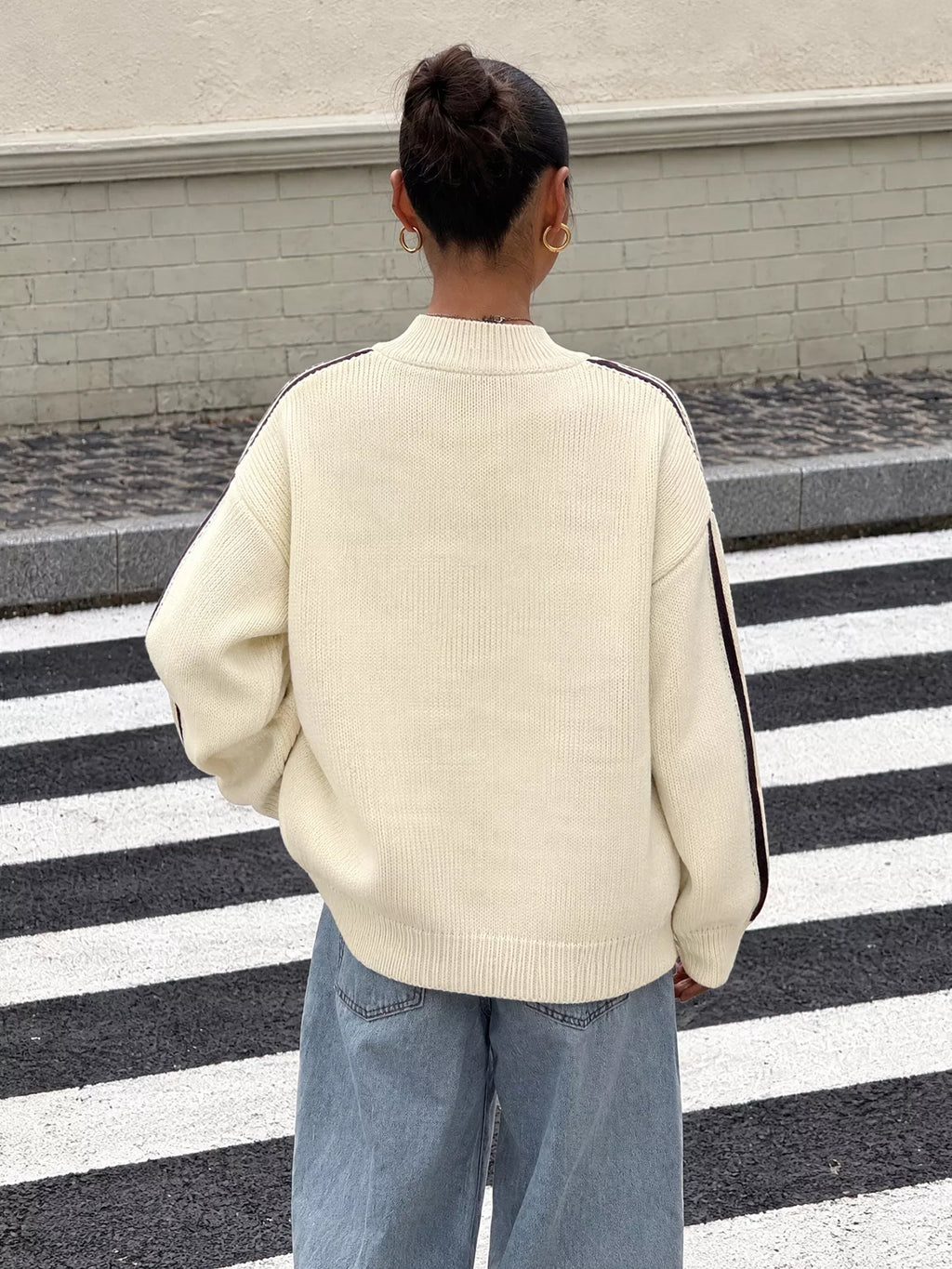View 6 of the cardigan with Chinese knot buttons and contrast stripes down the sides.