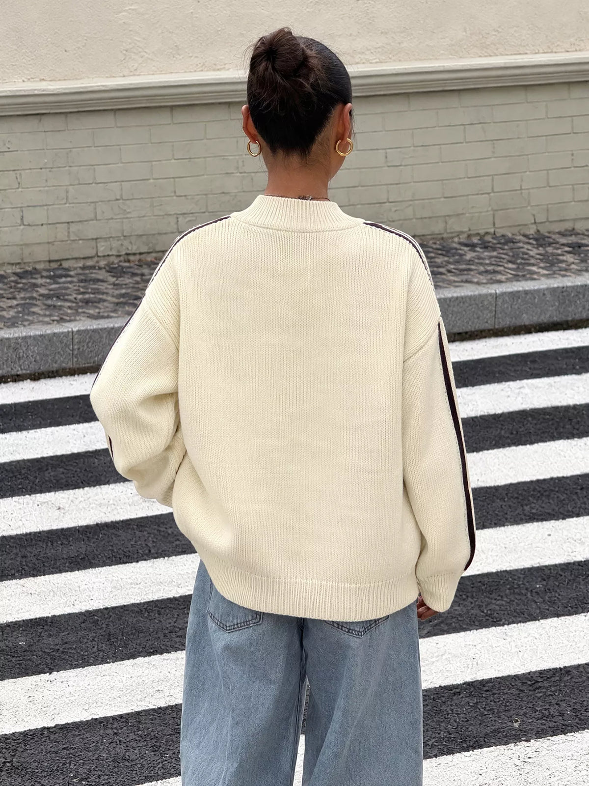 View 6 of the cardigan with Chinese knot buttons and contrast stripes down the sides.