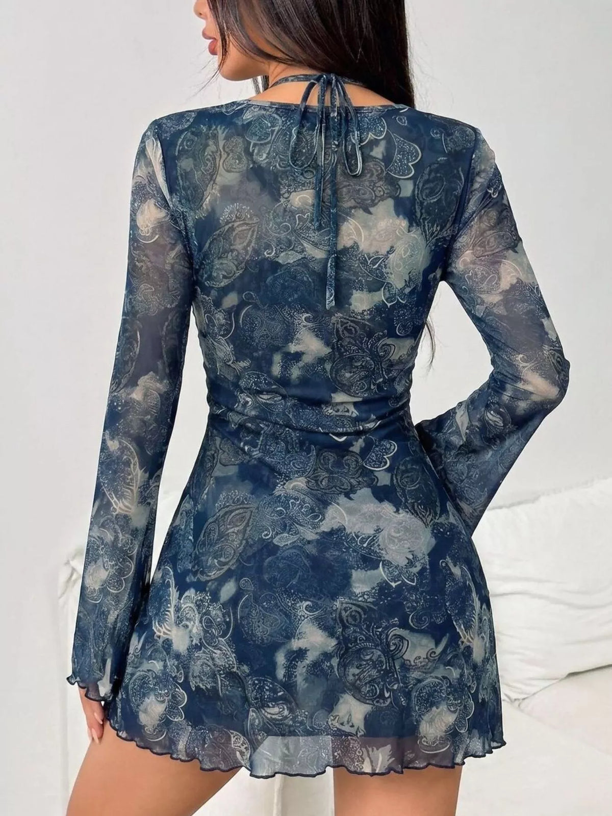View 4 of the long-sleeve mesh mini dress with cutouts, a tie, and a lining.