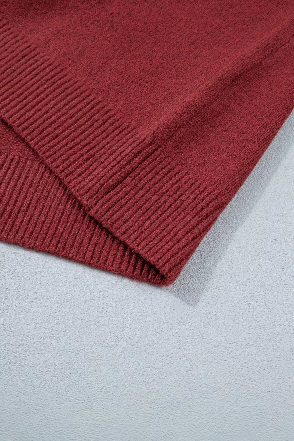 View 12 of the burgundy crewneck sweater with a white snowflake geometric band and a fair-isle yoke.