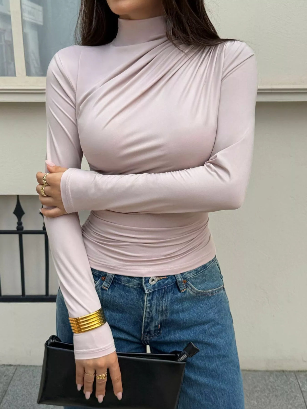 View 3 of the taupe long-sleeve mock-neck top with ruching down one side.