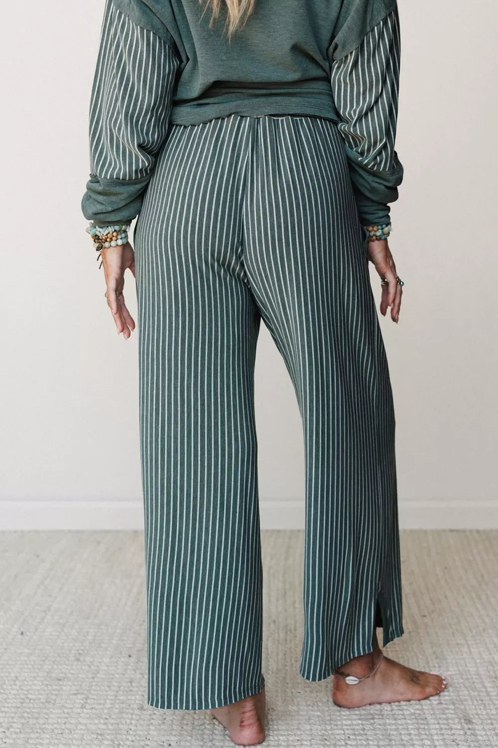 View 9 of the striped two-piece set with a long-sleeve top and drawstring pants.