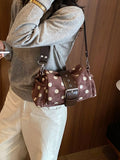 Small polka-dot shoulder bag in PU leather.