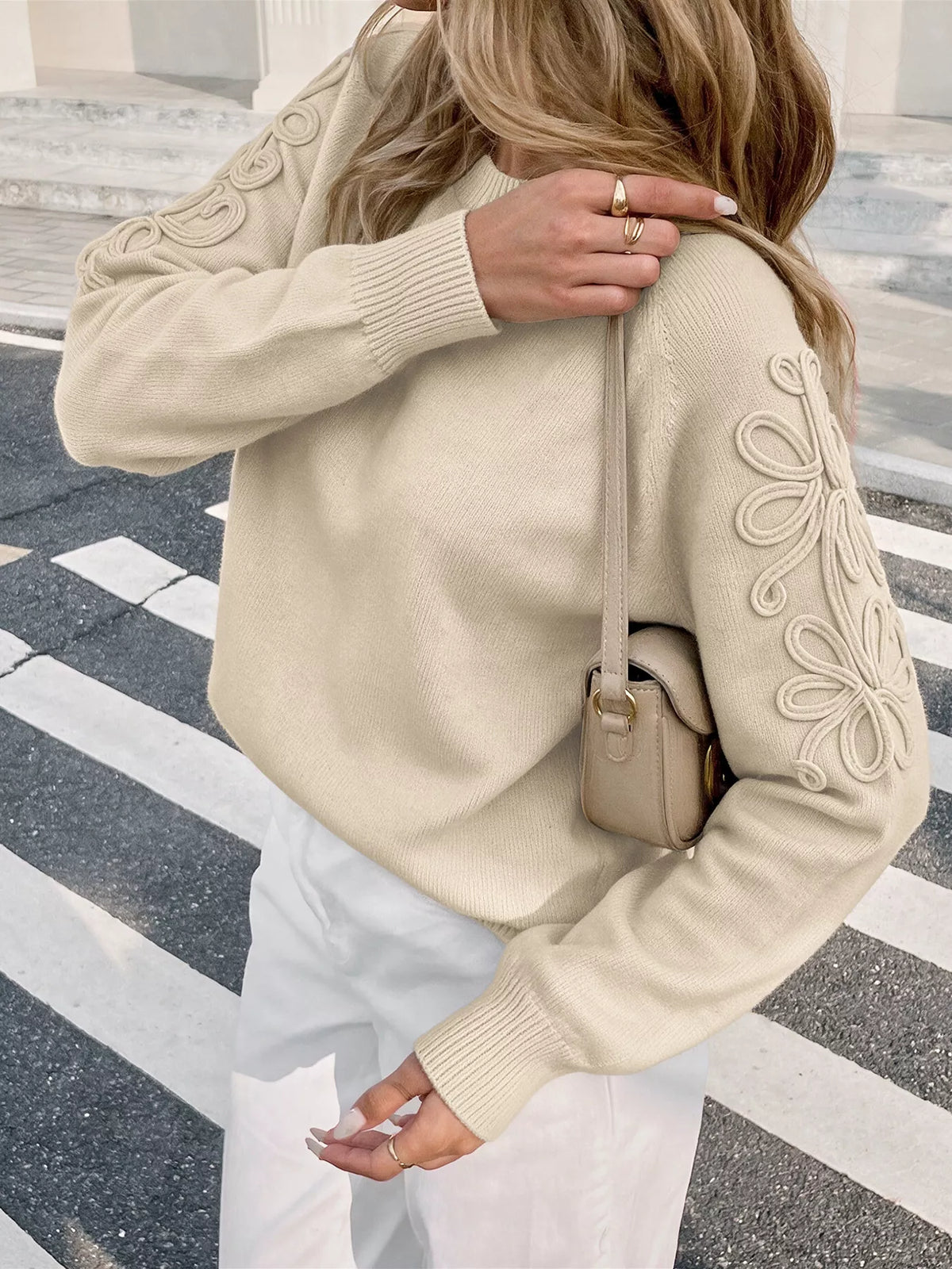 View 4 of the floral appliqué sweater with raglan sleeves.