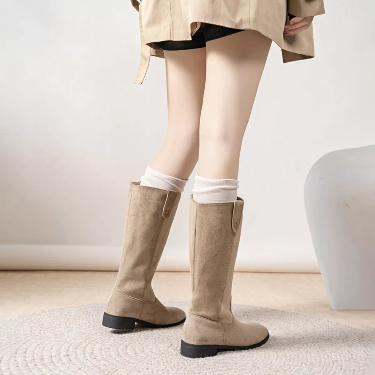 View 7 of the suede pull-on boots with a round toe and a mid heel.