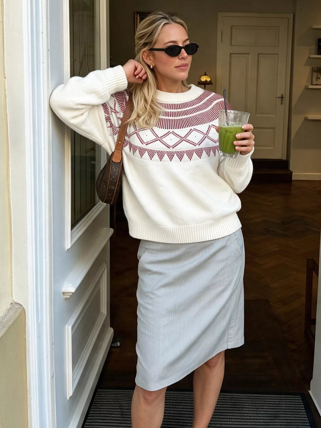 View 4 of the crewneck knit sweater covered in a geometric pattern.