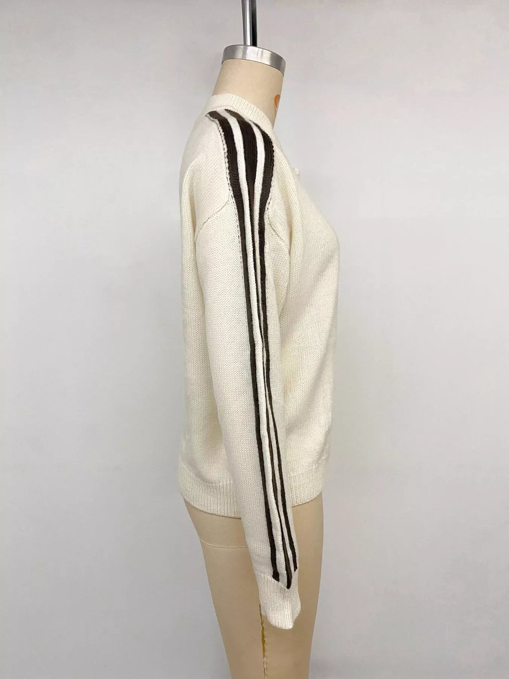 View 13 of the cardigan with Chinese knot buttons and contrast stripes down the sides.