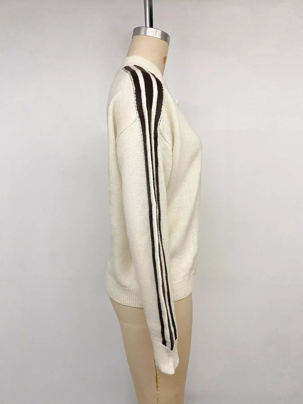View 13 of the cardigan with Chinese knot buttons and contrast stripes down the sides.