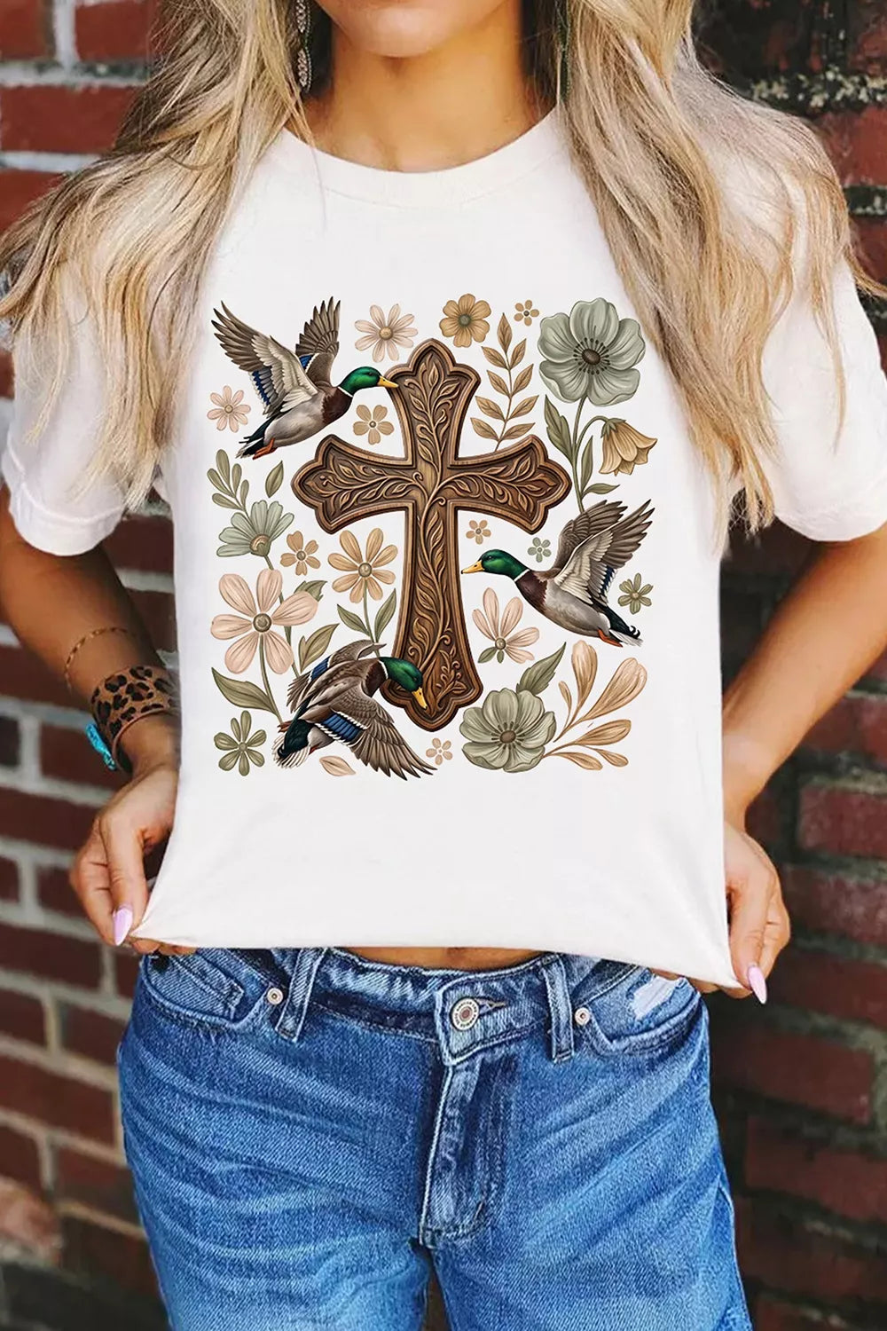 View 4 of the cream short-sleeve tee with a cross, mallard, and flower graphic.