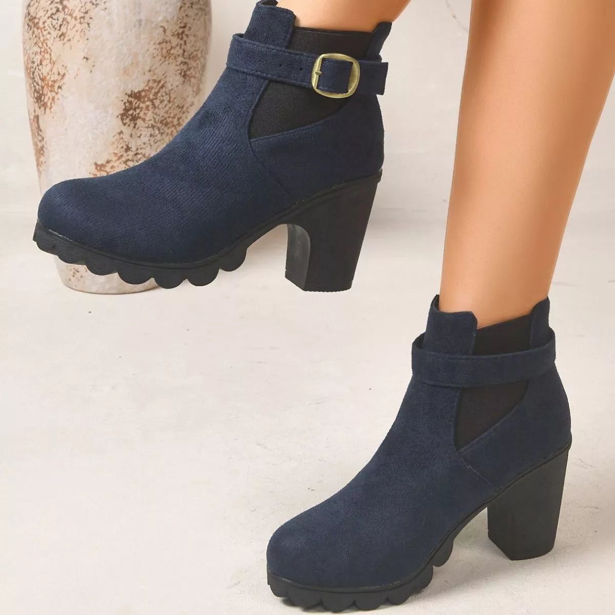 View 5 of the suede boots with a round toe and a high block heel.