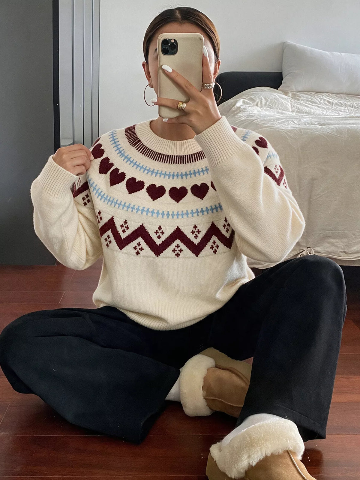 View 4 of the crewneck sweater with a heart pattern through the knit.