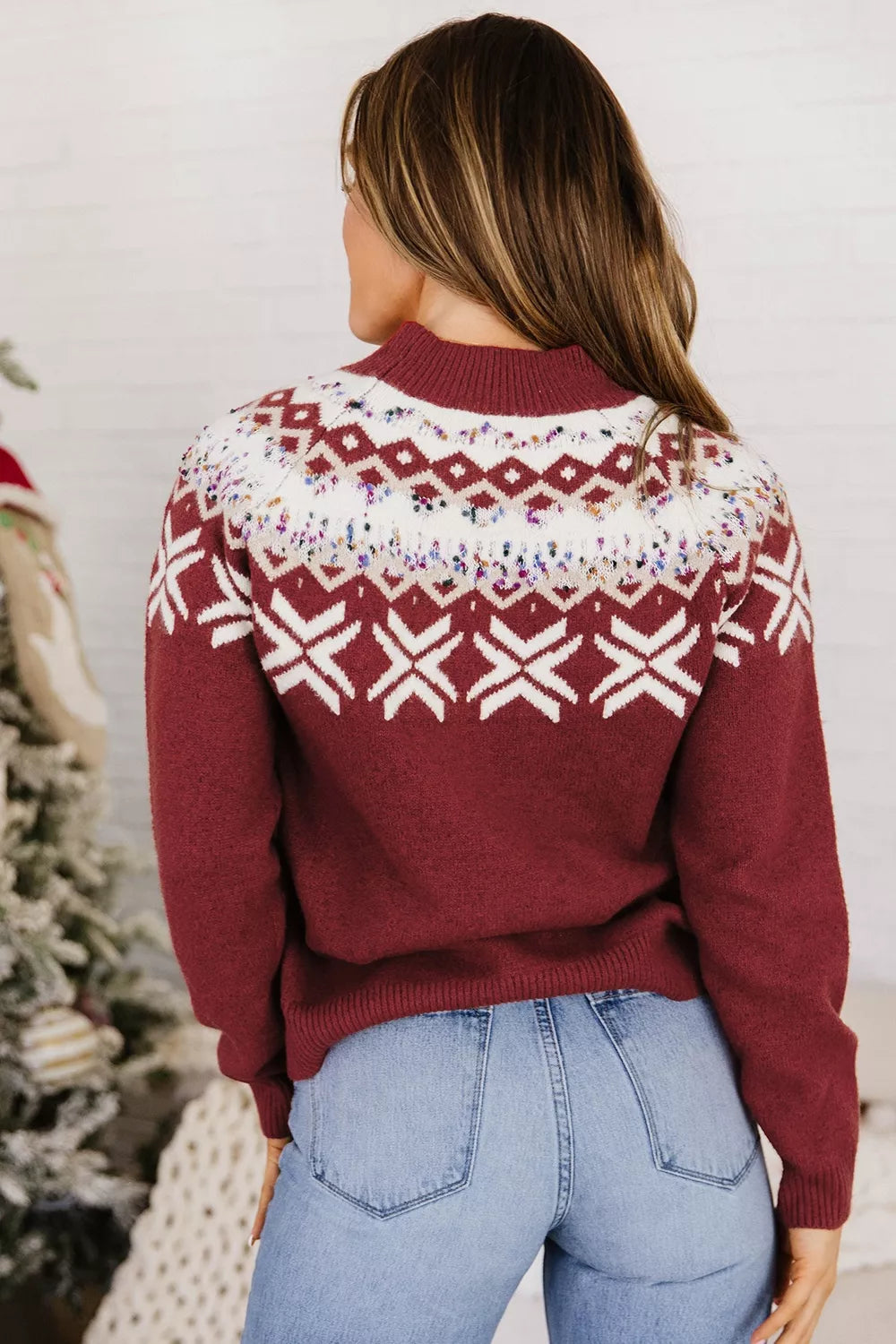 View 5 of the burgundy crewneck sweater with a white snowflake geometric band and a fair-isle yoke.