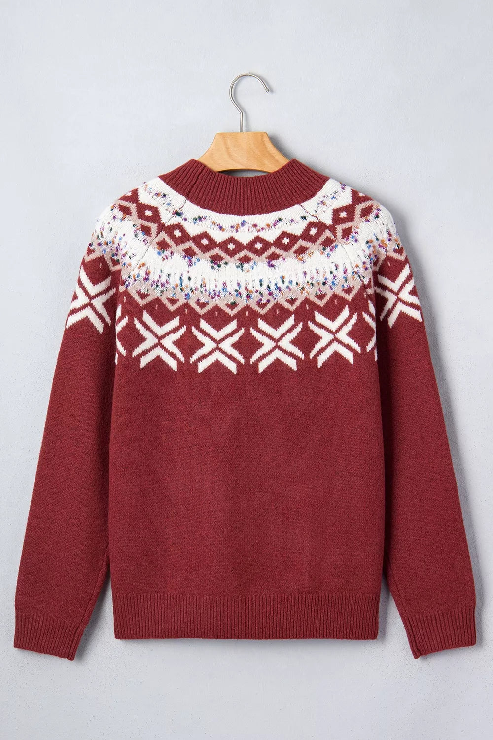 View 7 of the burgundy crewneck sweater with a white snowflake geometric band and a fair-isle yoke.