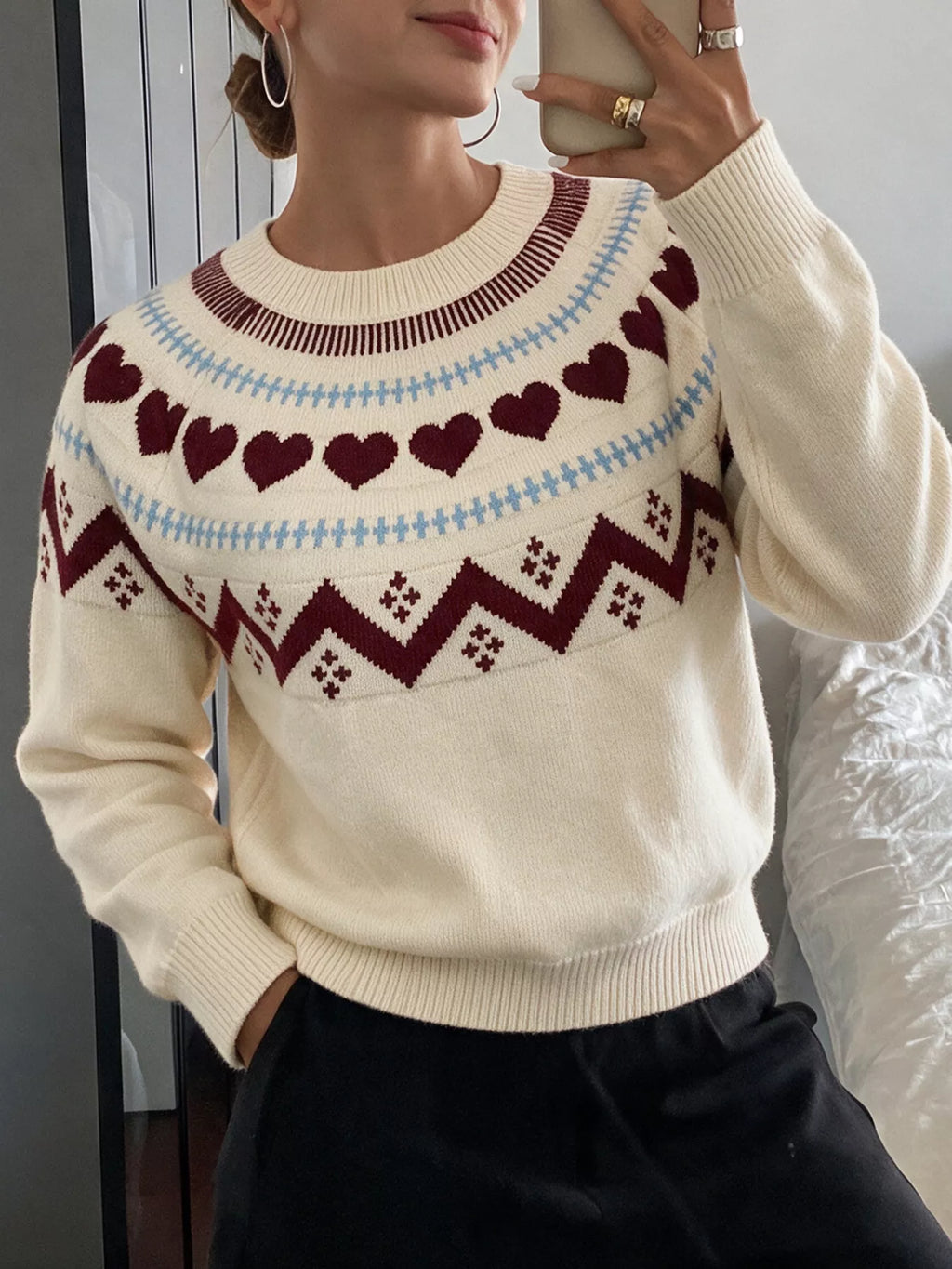 View 5 of the crewneck sweater with a heart pattern through the knit.