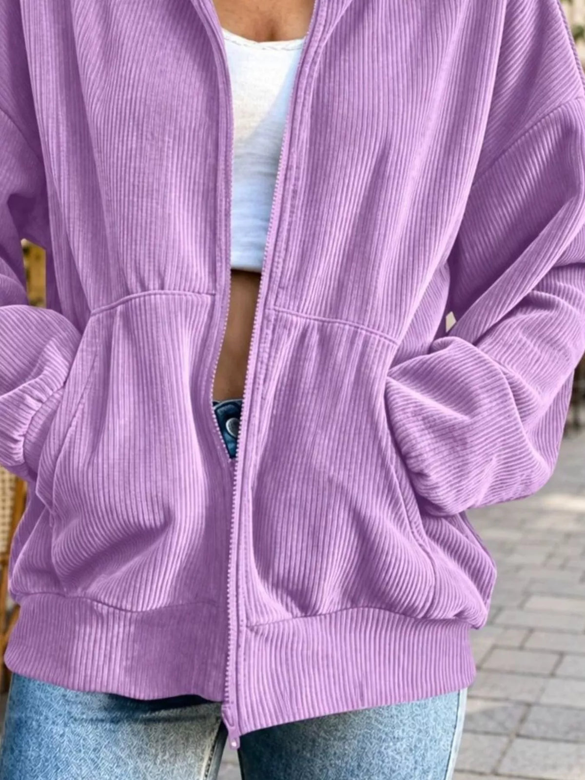 View 15 of the unlined corduroy zip jacket with dropped shoulders and pockets.
