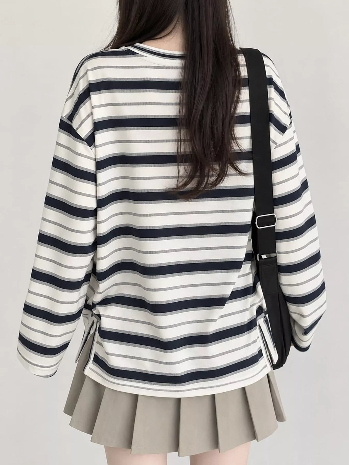 View 4 of the oversized navy-and-cream striped tee with dropped shoulders.