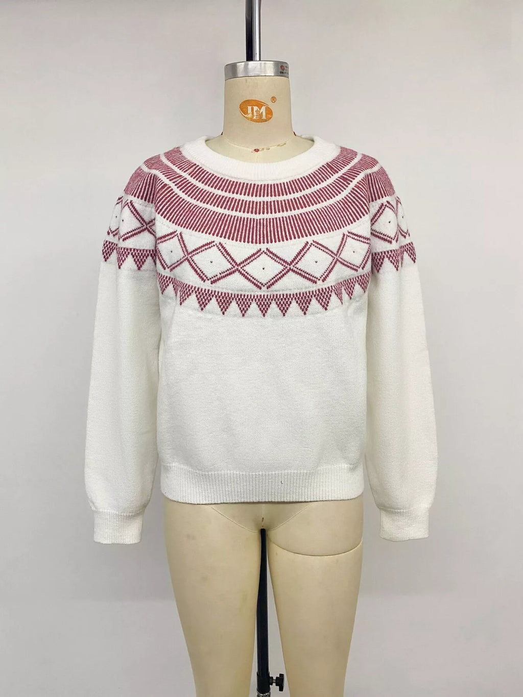 View 13 of the crewneck knit sweater covered in a geometric pattern.