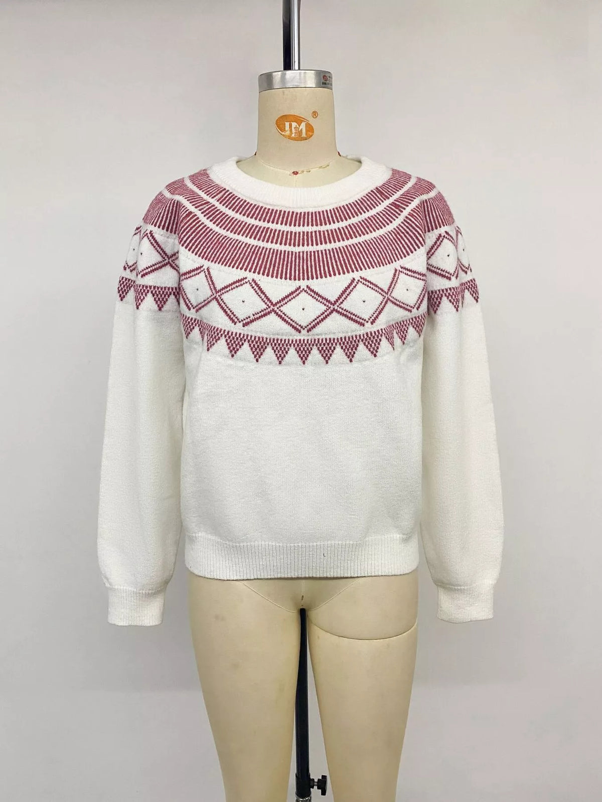 View 13 of the crewneck knit sweater covered in a geometric pattern.